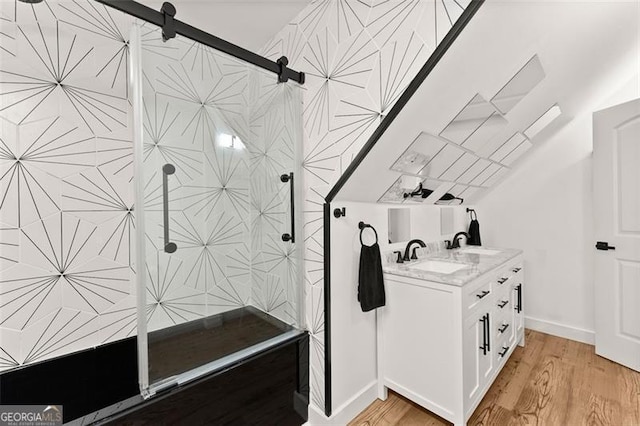 bathroom with vanity, wood-type flooring, and walk in shower