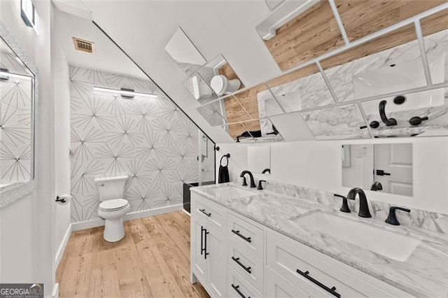 bathroom featuring toilet, vanity, and hardwood / wood-style flooring