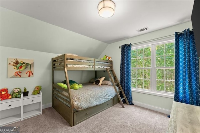 bedroom with lofted ceiling, light carpet, and multiple windows