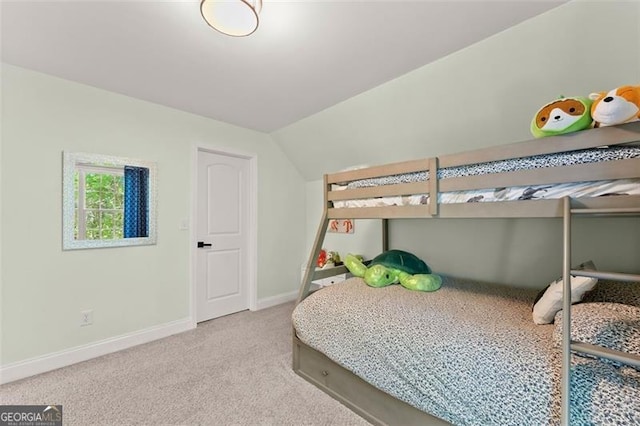 carpeted bedroom with lofted ceiling