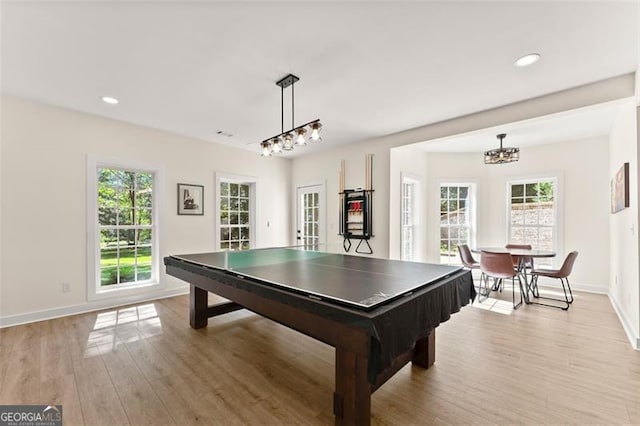 rec room featuring baseboards, a wealth of natural light, and light wood-style floors