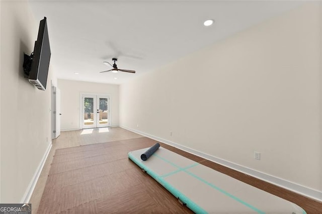 exercise area with french doors, hardwood / wood-style flooring, and ceiling fan