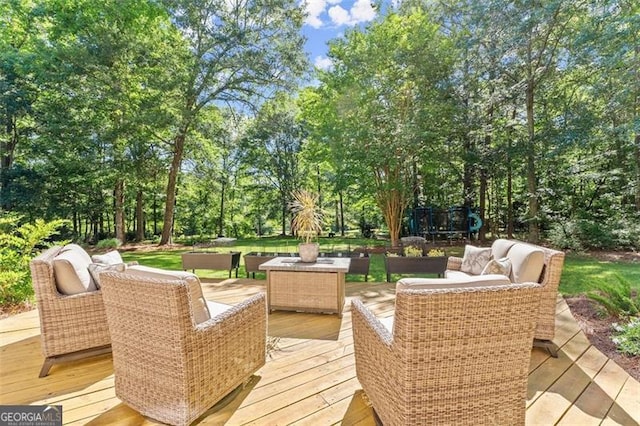 deck with an outdoor hangout area and a trampoline