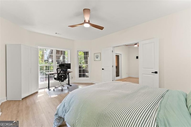 bedroom with baseboards, ceiling fan, and light wood-type flooring