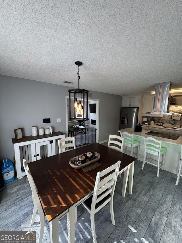 dining room with a chandelier and sink