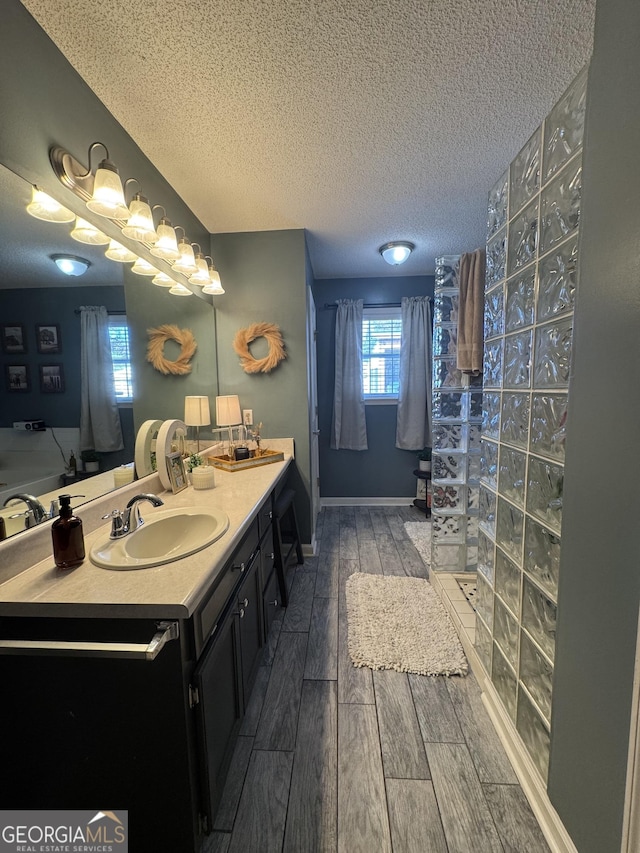 bathroom featuring a textured ceiling and vanity