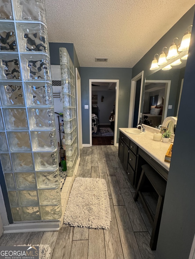 bathroom with a textured ceiling and vanity