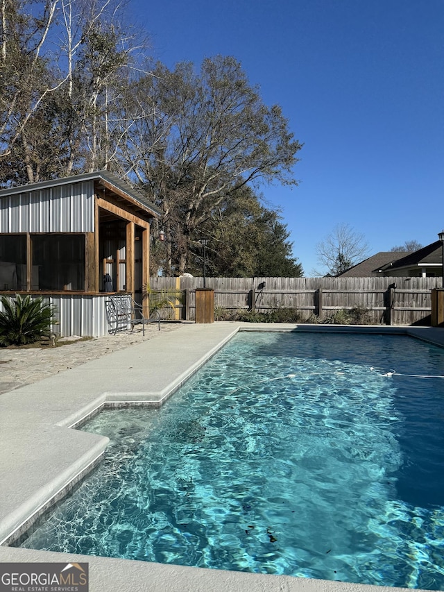 view of swimming pool with a patio and exterior bar