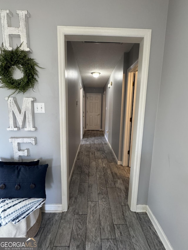 hall featuring a textured ceiling