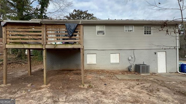 back of house with a deck and central air condition unit