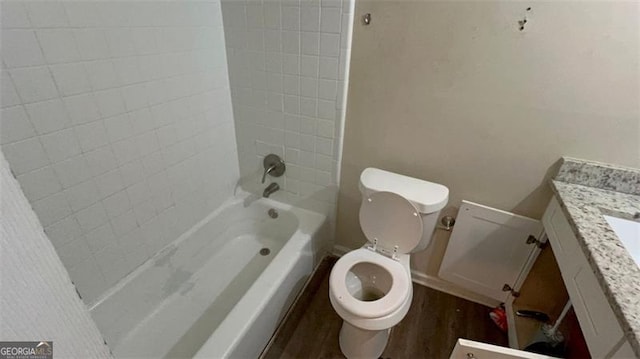 full bathroom featuring wood-type flooring, vanity, toilet, and tiled shower / bath