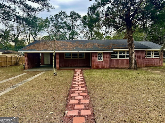 ranch-style house with a carport and a front yard