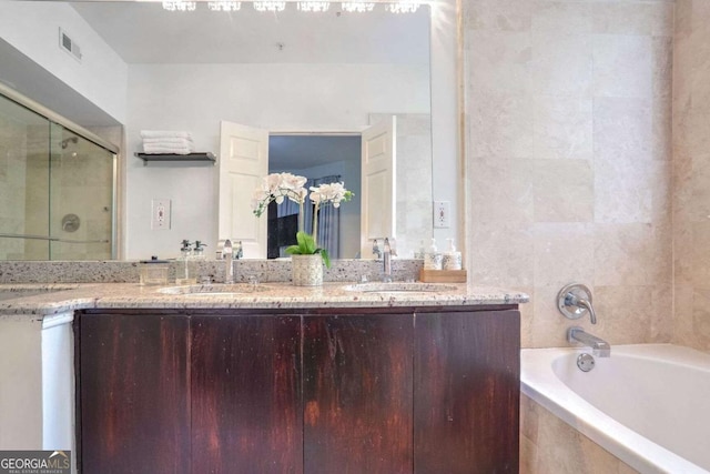 bathroom featuring separate shower and tub and vanity