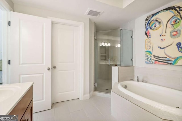 bathroom with tile patterned flooring, vanity, and separate shower and tub