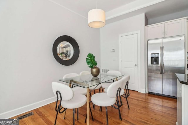 dining area with hardwood / wood-style flooring