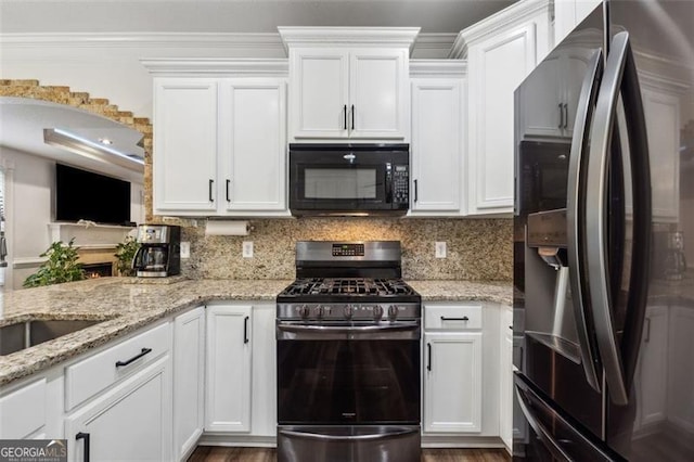 kitchen featuring white cabinets, backsplash, gas stove, and fridge with ice dispenser