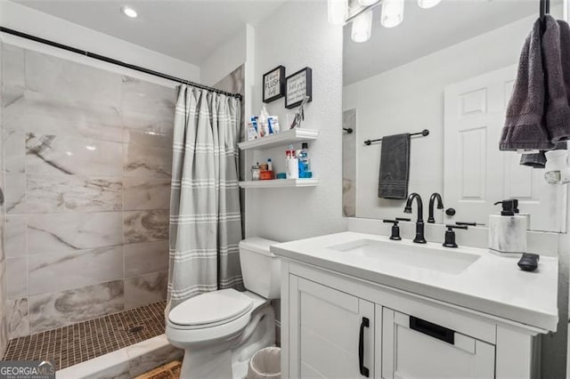 bathroom featuring toilet, vanity, and walk in shower