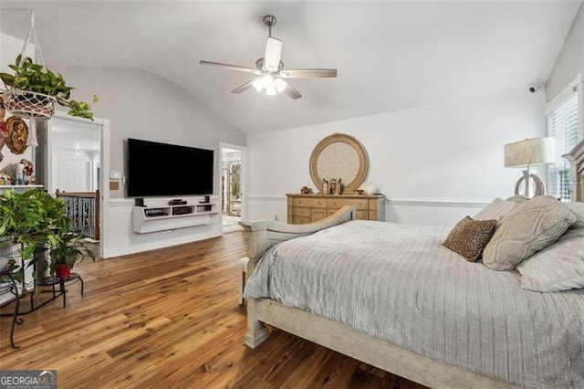 bedroom featuring ensuite bath, hardwood / wood-style flooring, vaulted ceiling, and ceiling fan