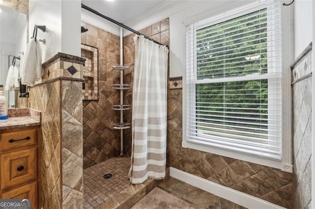 bathroom featuring a shower with shower curtain, vanity, and ornamental molding