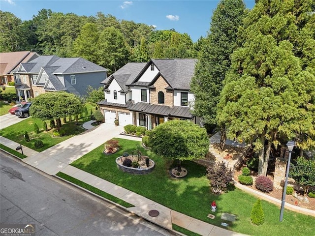 view of front of property featuring a garage and a front lawn