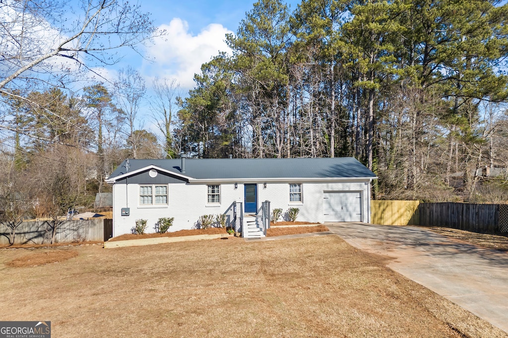 ranch-style house with a front lawn and a garage