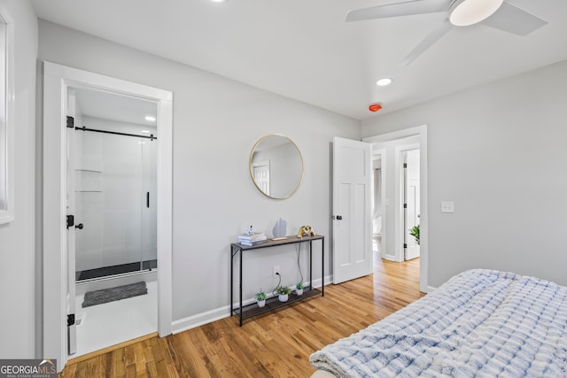 bedroom with ensuite bathroom, hardwood / wood-style floors, and ceiling fan