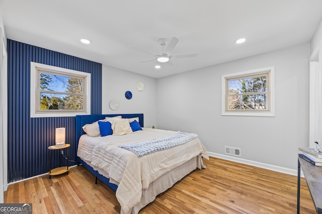 bedroom with wood-type flooring and ceiling fan