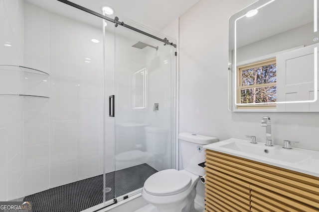 bathroom featuring an enclosed shower, vanity, and toilet