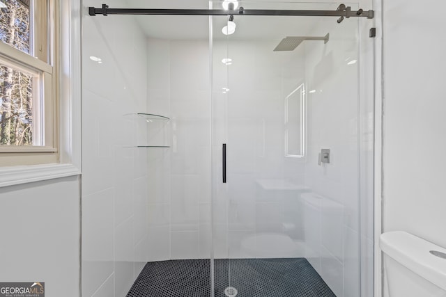 bathroom with toilet and walk in shower