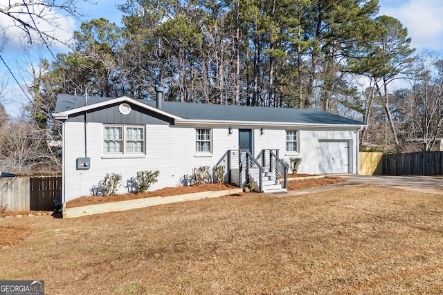 ranch-style home with a front yard and a garage