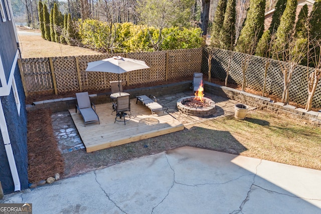 view of patio / terrace featuring a wooden deck and a fire pit