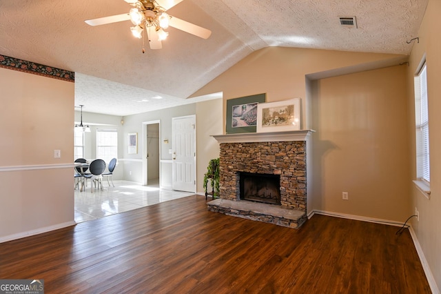 living room featuring a textured ceiling, hardwood / wood-style flooring, ceiling fan, and lofted ceiling