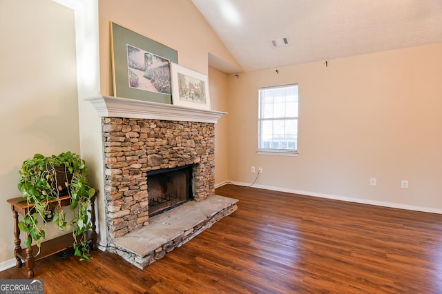 unfurnished living room featuring a fireplace, dark hardwood / wood-style floors, and vaulted ceiling