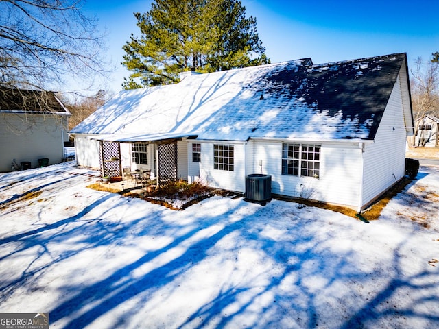 snow covered property with cooling unit