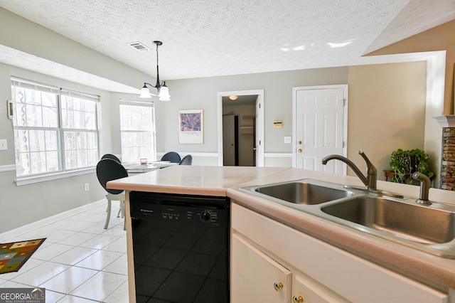 kitchen with dishwasher, sink, pendant lighting, a textured ceiling, and light tile patterned floors