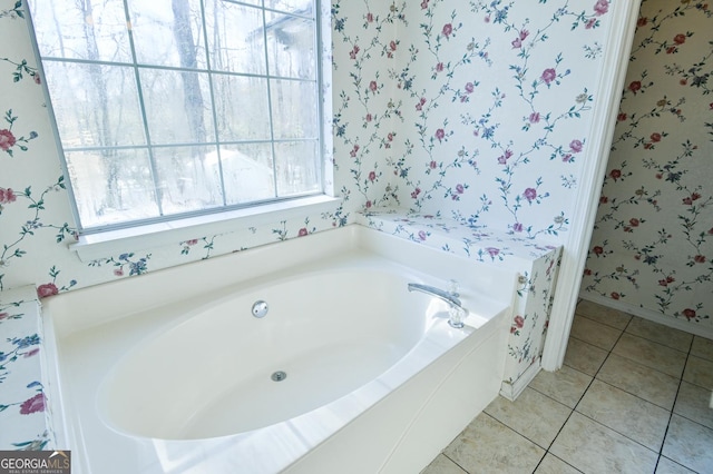 bathroom with tile patterned floors and a bathing tub