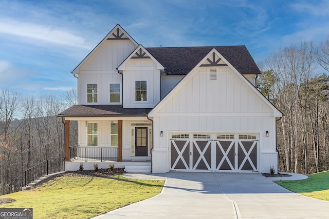 view of front of house featuring a garage, covered porch, and a front lawn