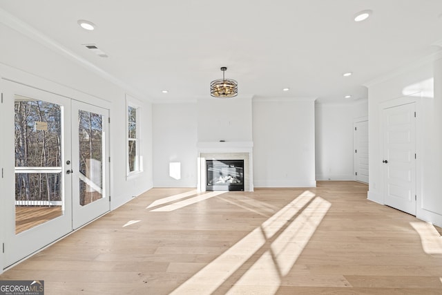 unfurnished living room with a fireplace, french doors, light hardwood / wood-style floors, and ornamental molding