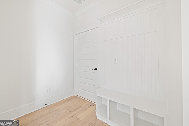 mudroom featuring hardwood / wood-style flooring and ornamental molding