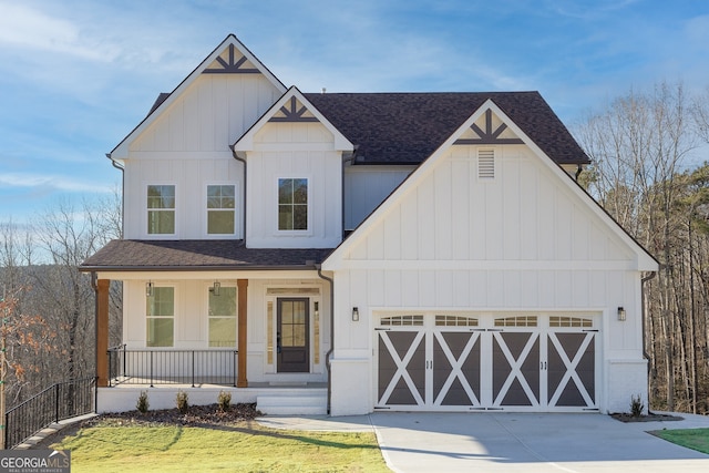 modern farmhouse featuring covered porch, a garage, and a front yard