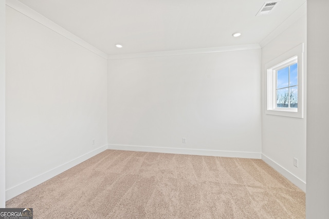 carpeted spare room featuring crown molding