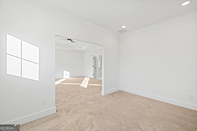 carpeted empty room with ceiling fan and crown molding