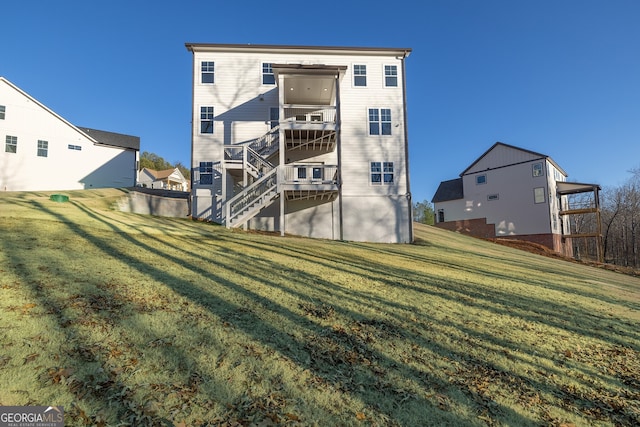 back of house featuring a yard and a deck