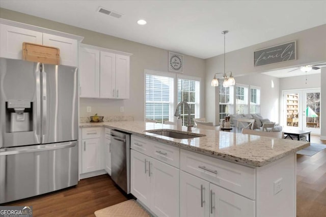 kitchen featuring appliances with stainless steel finishes, ceiling fan, dark wood-type flooring, sink, and white cabinets