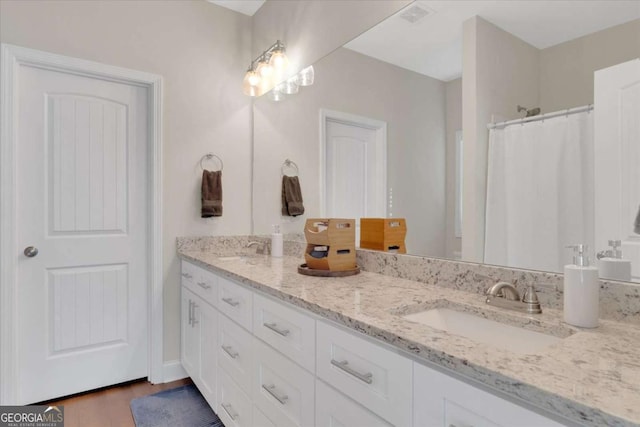 bathroom featuring vanity and wood-type flooring