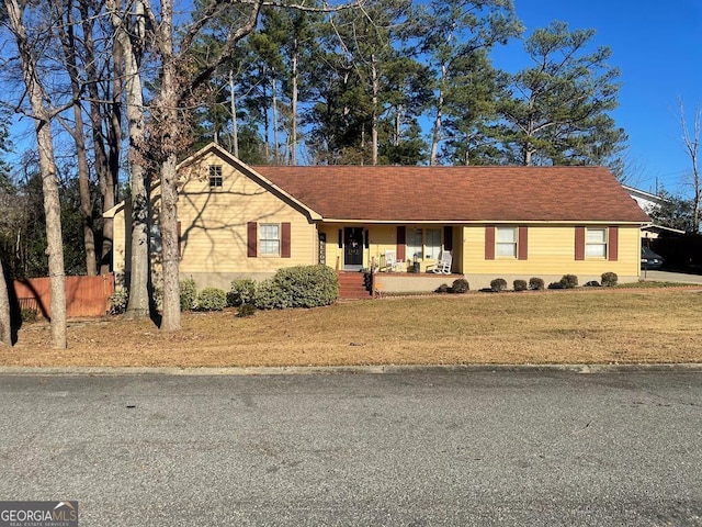 ranch-style house featuring a front yard and a porch