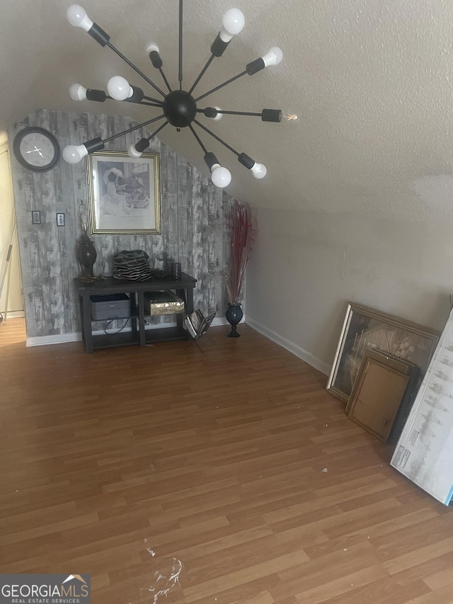 unfurnished living room featuring wood-type flooring and a textured ceiling