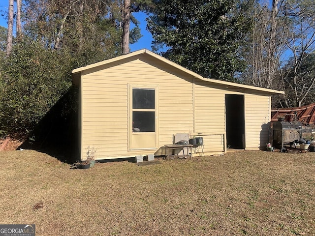 view of outbuilding featuring a lawn