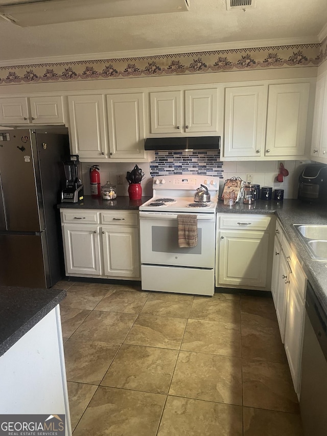 kitchen featuring appliances with stainless steel finishes, tasteful backsplash, tile patterned floors, sink, and white cabinetry