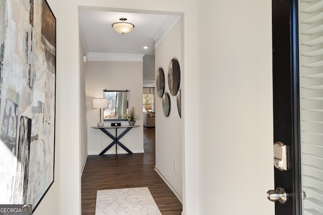 hall with dark hardwood / wood-style flooring and ornamental molding